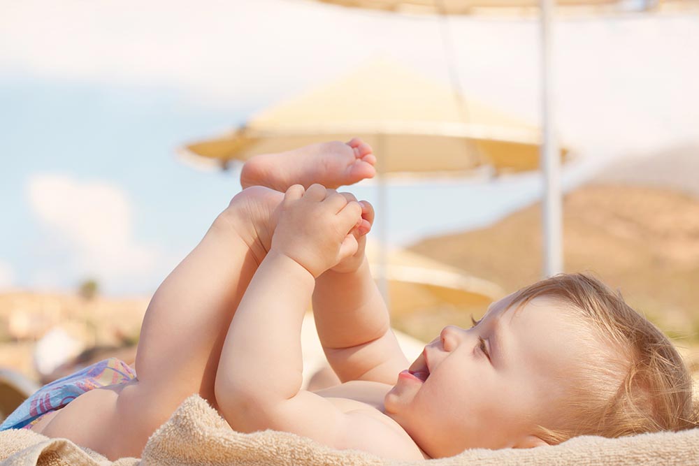 happy baby on beach